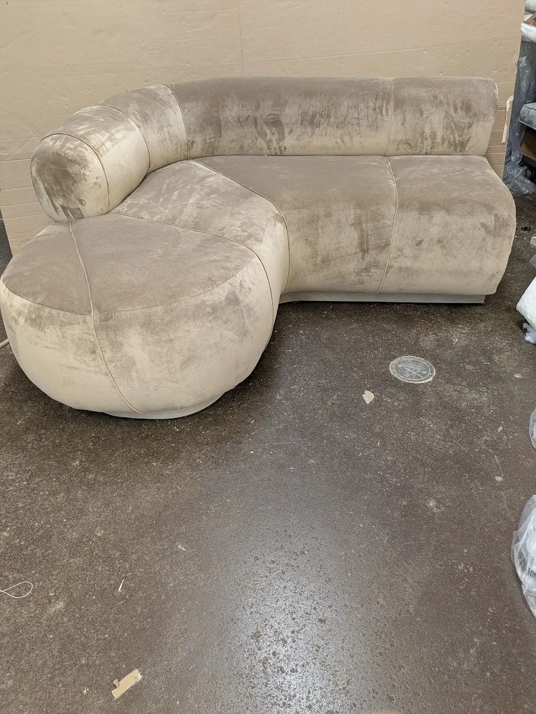 Curved velvet sofa with a rounded seat end