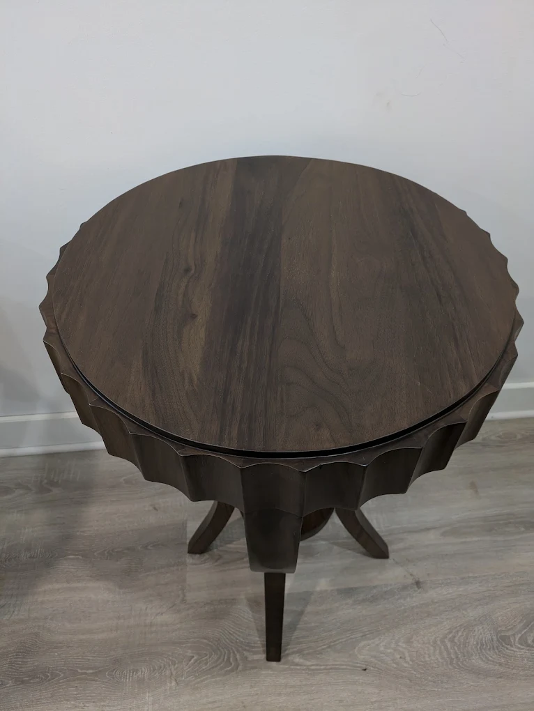 Round walnut side table with a fluted scalloped rim and splayed legs