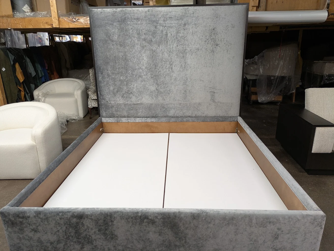 Gray velvet upholstered bed with a tall headboard, finished in the workshop